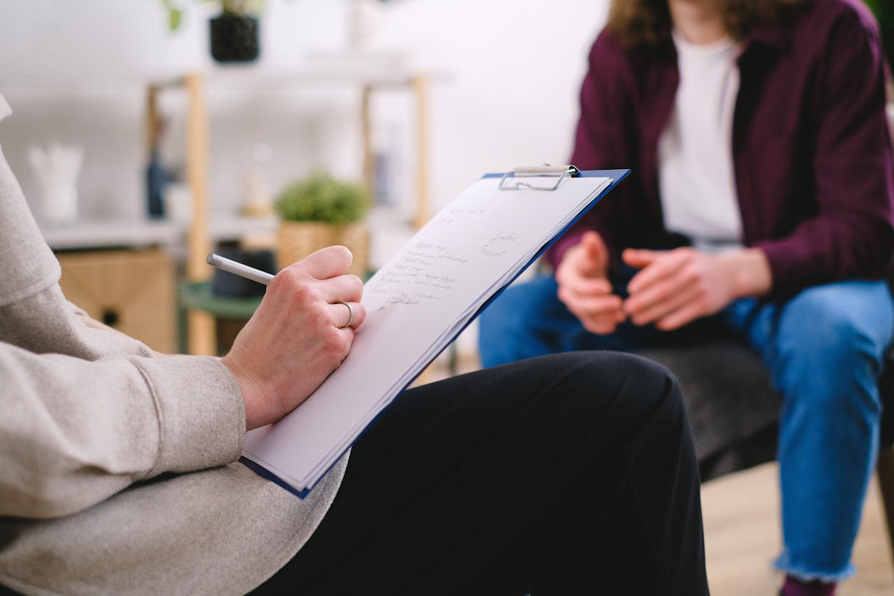 A psychologist taking notes during a career guidance session