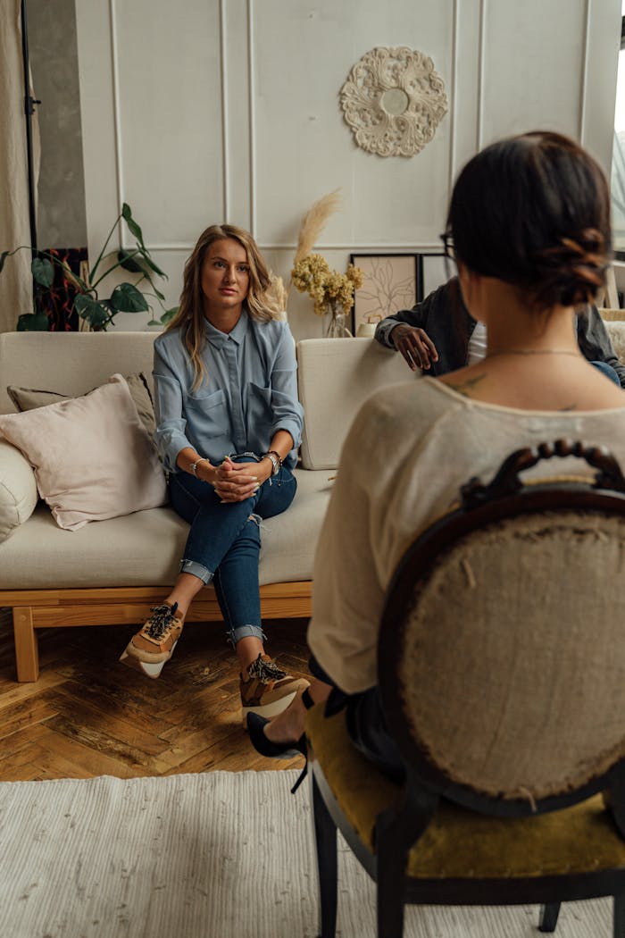 A woman speaking with a psychologist during a therapy session